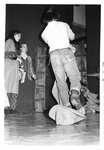 Male runs on stage while others stand in background or lay on floor