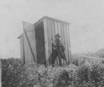 Alaskan Man Standing In front of Building by George Fox University Archives