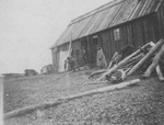 Native Alaskan People Standing by Building by George Fox University Archives