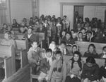 Alaskan People Sitting in a Church by George Fox University Archives