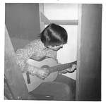 Man Plays Guitar in Corner by George Fox University Archives