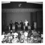 People in Robes Perform on Stage by George Fox University Archives