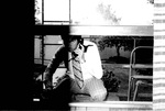 Barry Hubbell sits in window while on the phone by George Fox University Archives