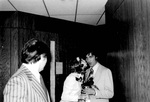 Barry Hubbell receives a rose and kiss on the cheek from woman by George Fox University Archives