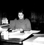 Staff member works at desk by George Fox University Archives