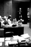 Staff member works at desk in office