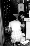 Staff members look through filing cabinet together by George Fox University Archives