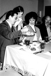 Staff members eat together at a dinner by George Fox University Archives
