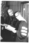 Two Men Reading and Preparing at the Fall Convocation in 1973 by George Fox University Archives
