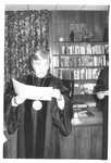 Man Reading a Paper at the Fall Convocation in 1973 by George Fox University Archives