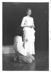 Male kneels on ground and looks up to female by George Fox University Archives