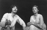 Male and female actors kneel close to ground and look into the distance by George Fox University Archives