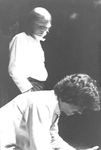 Actor with dark hair leans over as actor with light hair stands in background by George Fox University Archives