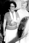 Kathleen Gregory holds arm in sling by George Fox University Archives