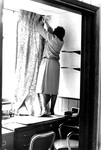 Ironing and Installing Drapes in an Office