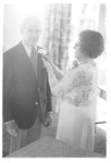 Woman Fixing Mans Boutonniere at a Class Reunion by George Fox University Archives