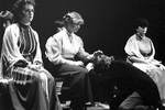 Actresses sit while male actor cries on floor by George Fox University Archives