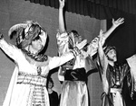 Actors perform with hands in the air by George Fox University Archives