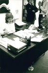 Susie McCarty sits at her desk by George Fox University Archives