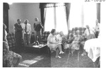 People Sitting on Couches and Talking at an Alumni Reception by George Fox University Archives