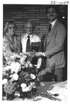 People Standing Behind a Podium at an Alumni Reception by George Fox University Archives