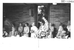 People Standing Behind a Table at an Alumni Reception by George Fox University Archives