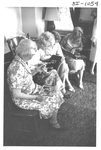 Women Looking at Photo Albums at an Alumni Reception by George Fox University Archives