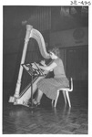 Woman Playing the Harp at the Alumni Talent Show in 1983 by George Fox University Archives