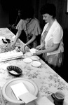 Glenna Jensen and Joan Stebbins serve cake at Jim Jackson's farewell party